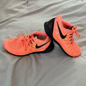 Neon orange Nike free 5.0 shoes